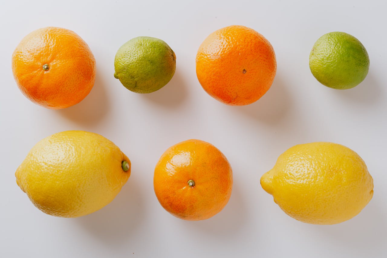 A vibrant citrus collection featuring lemons, limes, and oranges on a white background.
