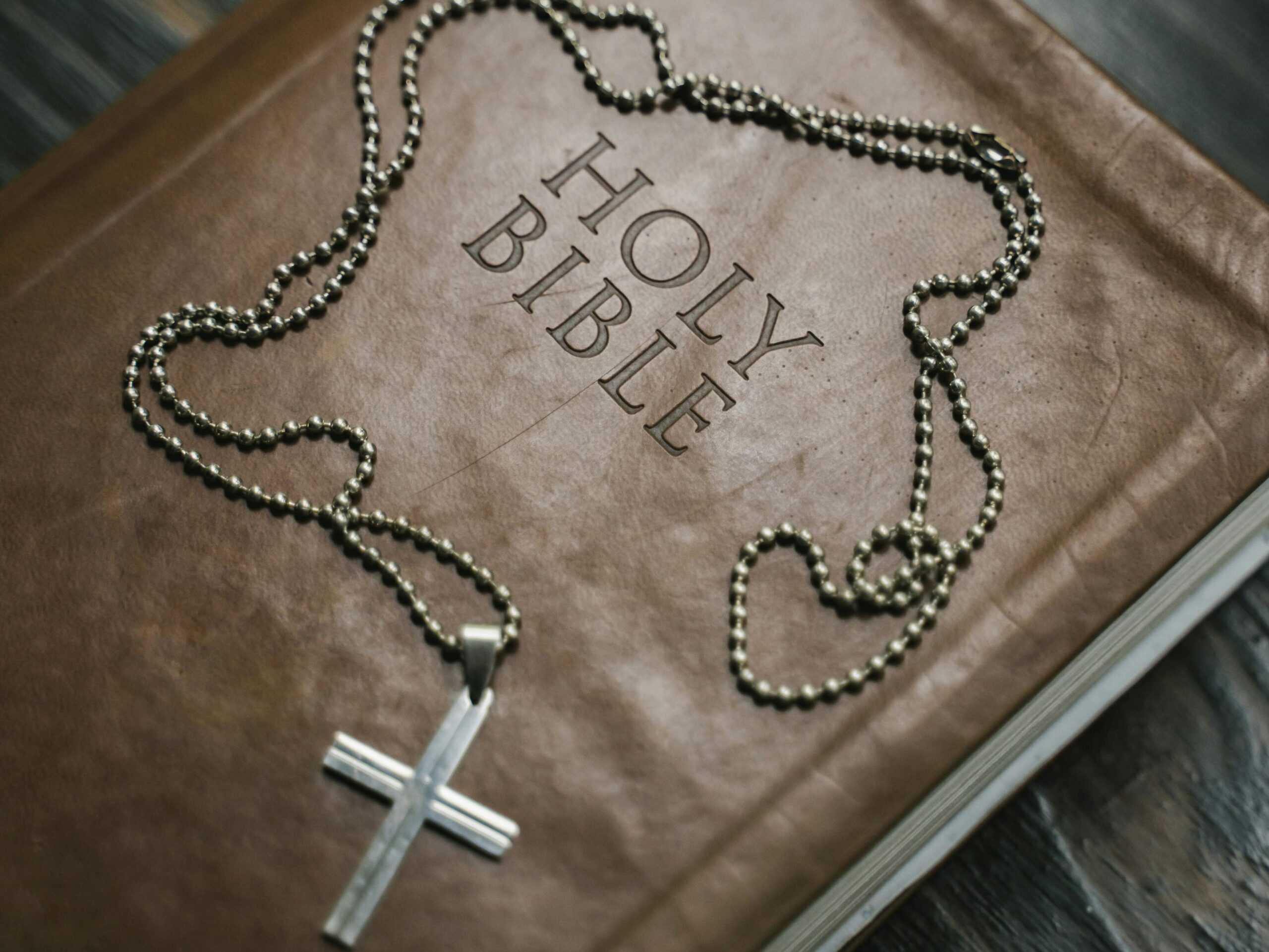 pexels photo 5199797 5199797 Close-up image of a Holy Bible with a cross necklace, emphasizing Christian faith.
